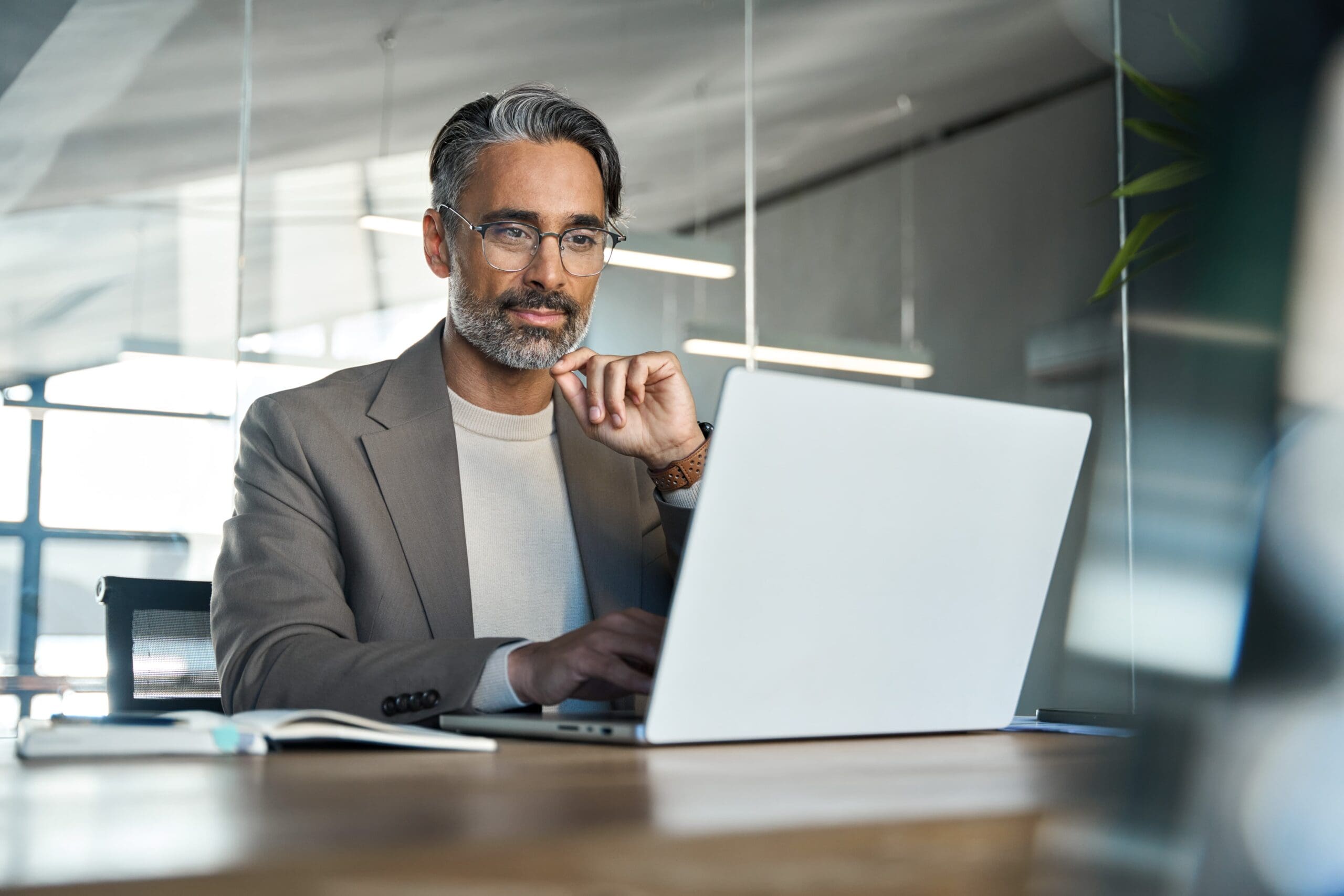 Professional-looking man looing over potential real estate investments
